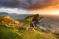 Dramatic sunset at famous landmark Neist Point Lighthouse on the Isle of Skye. Royalty Free Stock Photo