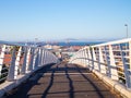 Bridge over Nelson Mandela Boulevard. Man in face mask walking along pathway.