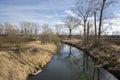 Nemosicka stran forest on the end of winter time, sunlight in branches, way throught amazing natural area, river