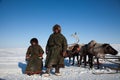 The Nenets man nad his son near deers Royalty Free Stock Photo