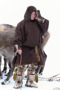 Nenets reindeer herder in traditional fur clothes covering the f