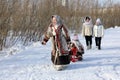 Nenets woman in national clothes carries a child in the north of Siberia