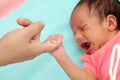 Newborn baby gripping mothers finger