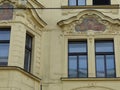 Neoclassic style paintings over the windows of an ancient building of Prague in Czech Republic.