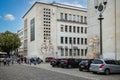 Neoclassical statue on the side of the modernist buildings of the University of Coimbra, Portugal