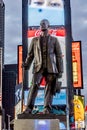 Neon advertising of News, brands and theaters at times square with statue of George M. Cohan at times square