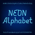 Neon alphabet font. Blue neon lowercase, uppercase letters and numbers on a dark background Royalty Free Stock Photo