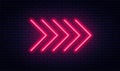 Neon arrow sign. Glowing neon arrow pointer on brick wall background. Retro signboard with bright neon tubes