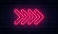 Neon arrow sign. Glowing neon arrow pointer on brick wall background. Retro signboard with bright neon tubes Royalty Free Stock Photo