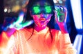 Neon  asian woman dancing. Fashion model woman in neon light, portrait of beautiful model with fluorescent make-up, Art and future Royalty Free Stock Photo