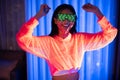 Neon  asian woman dancing. Fashion model woman in neon light, portrait of beautiful model with fluorescent make-up, Art and future Royalty Free Stock Photo