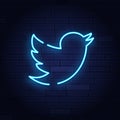 Neon bird icon on brick wall. Social network design element. Night bright neon sign, colorful billboard, light banner. Vector