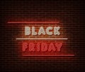 Neon Black Friday text banner vector isolated on brick wall. Special price offer light symbol, decoration text effect. Neon black Royalty Free Stock Photo