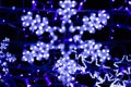 Neon, blue glowing snowflakes, colorful background, out of focus