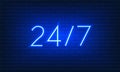 Neon blue sign Open 24 7 hours on brick wall background. Vintage electric signboard with bright neon lights. Blue light falls. 24 Royalty Free Stock Photo