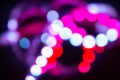 Neon bokeh lights on black. Bright abstract blurred background