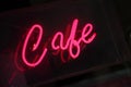 Neon cafe sign, vivid pink, illuminated at night Royalty Free Stock Photo