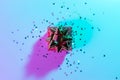 Neon Christmas winter background. Xmas gift box with shine lights. Holiday decoration on neon abstract gradient backdrop Royalty Free Stock Photo