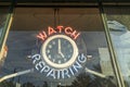 A neon clock hangs in the window of the Old Time Clock and Watch Repair shop in Grants Pass, Oregon, USA - October 30, 2022 Royalty Free Stock Photo