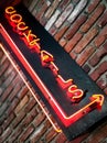 Neon cocktail sign on weathered brick