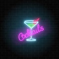 Neon cocktails bar or cafe sign on dark brick wall background. Glowing gas advertising with glass of alcohol shake. Royalty Free Stock Photo