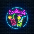 Neon cocktails bar sign in circle frame on dark brick wall background. Glowing gas advertising. Royalty Free Stock Photo