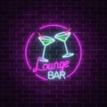 Neon cocktails lounge bar sign on dark brick wall background. Glowing gas advertising with glasses of alcohol shake. Royalty Free Stock Photo