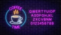 Neon coffee house signboard in circle frame with alphabet on a dark brick wall background. Hot drink and food cafe sign Royalty Free Stock Photo