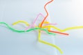 Neon colored pipe cleaners isolated on white background.