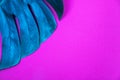 Neon colored Tropical plant green monstera leaf on acid plastic pink violet background. Royalty Free Stock Photo