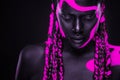 Neon colors. Pink and black body paint. Woman with face art. Young girl with colorful bodypaint. An amazing afro