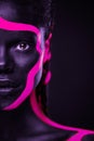 Neon colors. Pink and black body paint. Woman with face art. Young girl with colorful bodypaint. An amazing afro