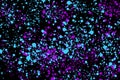 Neon cyan and purple random round paint splashes on black background. Abstract colorful texture