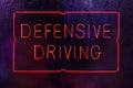 Vintage Neon Defensive Driving Sign in Rainy Window Royalty Free Stock Photo