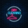 Neon dry cleaning glowing sign with hanger in circle frame. Cleaning service signboard design. Royalty Free Stock Photo