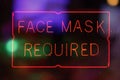 Neon Face Mask Required Sign in Rainy Store Window