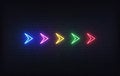 Neon futuristic arrow sign. Set of colorful glowing neon arrow pointer on brick wall background Royalty Free Stock Photo