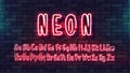 Neon futuristic hand font. Luminous tube alphabet uppercase lowercase letters on a dark brick wall background. Vector typeface