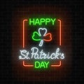 Neon glowing clover leaf sign in ireland flag colors on a dark brick wall background. Royalty Free Stock Photo