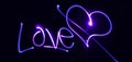 Neon heart and inscription Love on a dark background