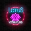 Neon glowing sign of lotus yoga club in circle frame on brick wall background. Street signboard of chinese gymnastics