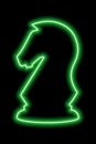 Neon green contour chess figure knight on a black background