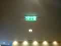 Neon Green fire exit sign on a high ceiling Royalty Free Stock Photo