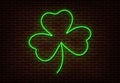 Neon green Shamrock sign vector isolated on brick wall. Light Happy Patric shop decoration element. Royalty Free Stock Photo