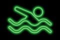Neon green silhouette of freestyle swimmer with waves on black background
