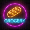 Neon grocery store glowing sign on a brick wall background. Food shop signboard with bread in a circle frame.