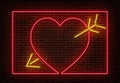 Neon heart with arrow sign vector isolated on brick wall. Light heart frame, shop decoration element