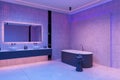 Neon hotel bathroom interior with bathtub, double sink and accessories