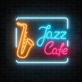 Neon jazz cafe and saxophone glowing sign on a dark brick wall background. Royalty Free Stock Photo