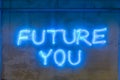 Neon letters `future you` on the wall. Conceptual message